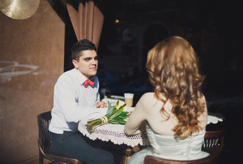 The lovely couple in love sits in restaurant