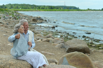 happy elderly couple at beach