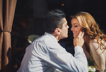 The lovely couple in love sits in restaurant