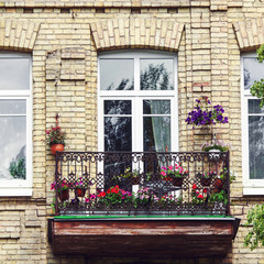 Fototapeta na wymiar Classic style balcony with flowers at summertime