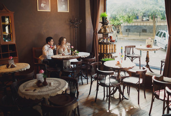 The lovely couple in love sits in restaurant