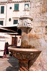 Fototapeta na wymiar Small lion head fountain in Dubrovnik
