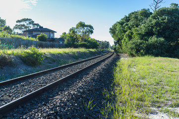 Fototapeta na wymiar Rail tracks winding into the distance in rural area.