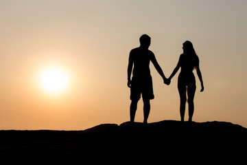 Fototapeta premium Silhouettes of a young couple.