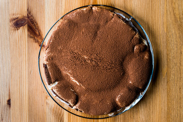 Homemade Tiramisu Cake on wooden surface.