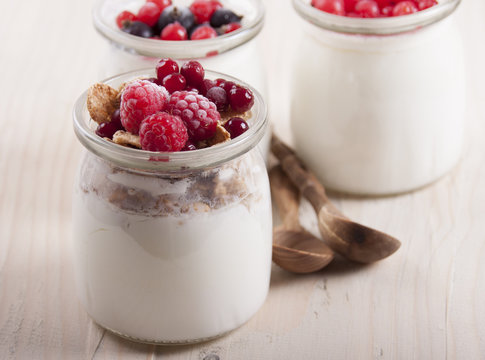 Homemade yogurt with frozen berries cranberries and raspberries