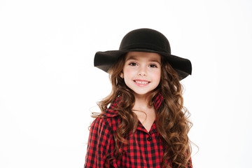 Portrait of happy little girl in plaid shirt and hat