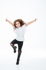 Full length of happy little girl jumping in the air