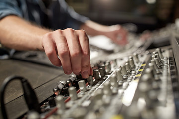 man using mixing console in music recording studio - obrazy, fototapety, plakaty