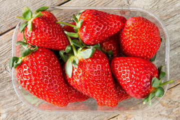 Plastic box full of strawberries