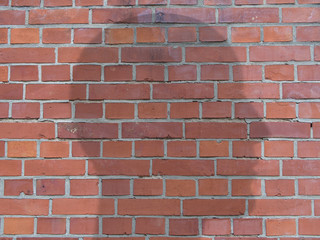 Obraz premium Head Shadow Silhouette On A Red Brick Wall, Background illustration