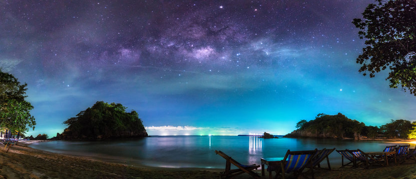 Panorama view of the milky way in night sky over beach, Thailand