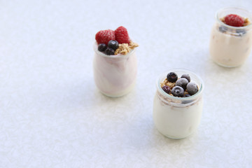 Yogurt and cream dessert with berries, cereals and muesli. healthy food. fitness concept