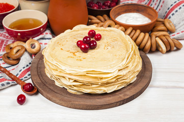 Russian pancake blini on white wooden background
