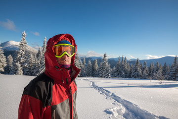 Traveler, man wearing a jacket with a hood and goggle looks at c