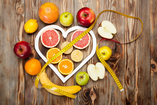 Fruit Diet, centimeter and a heart on  wooden background