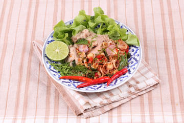 Spicy and sour mixed herb salad with tuna served .