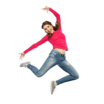 happy young woman jumping in air or dancing