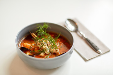 seafood soup with fish and blue mussels in bowl