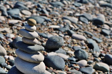 Fengshui rocks or pebbles stacked with a beach in the background