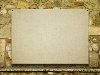 Blank nailed canvas frame on brown ancient stone wall background