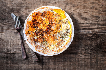 Herb omelette with cheese  in white  plate on wooden table