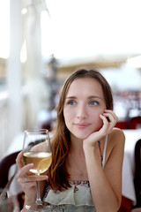 Girl with a glass of white wine