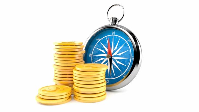 Compass with stack of coins isolated on white background