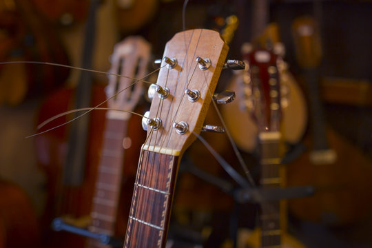 guitar neck detail in the music instrument shop with blurred background