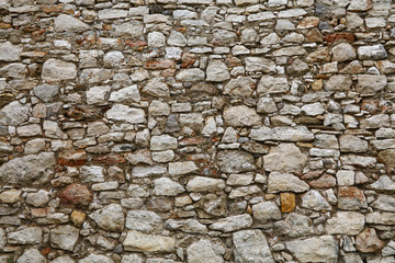 Old stone layered wall of fortress or castle