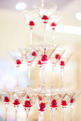 a pyramid of glasses with champagne