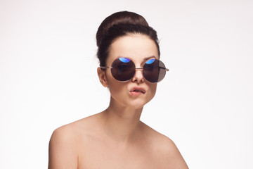 Fototapeta premium woman in black glasses on a light background