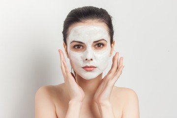 woman holding hands in front of face, cleansing mask
