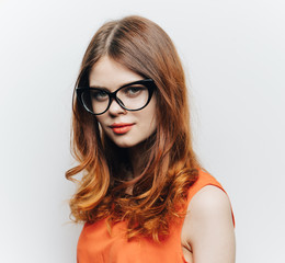 red-haired woman with glasses, orange shirt