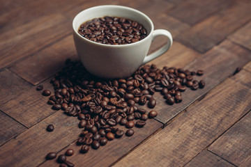 coffee beans in a cup and on a table