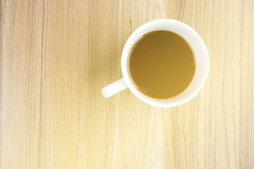 cup of coffee on wooden table  with sunlight from window