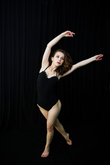 Girl dancer jumping and dancing on a black background. Studio sh © AS Photo Family