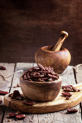 Raw pecan nuts in wooden bowl, rustic style, selective focus