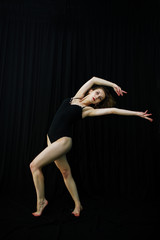 Girl dancer jumping and dancing on a black background. Studio sh © AS Photo Family