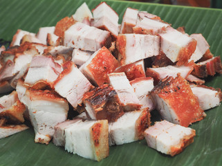 Deep fried pork belly (Crispy pork) placed on a banana leaf