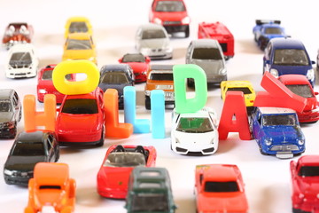 Toy cars with colourful letters sign HOLIDAY