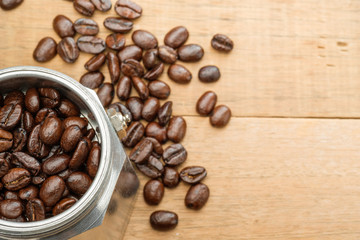 coffee beans in a moka pot on wooden table