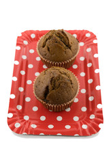 Tasty chocolate muffins on the red plate on the white background
