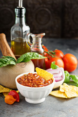 Homemade spicy tomato salsa with vegetables and olive oil
