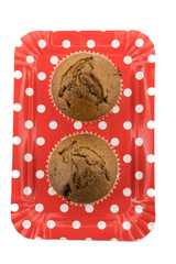 Tasty chocolate muffins on the red plate on the white background