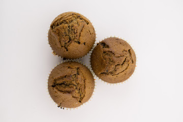 Tasty chocolate muffins on the white background