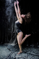 Girl dancer jumping and dancing in the white dust with flour on © AS Photo Family