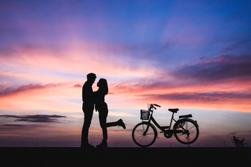 Fototapeta na wymiar Silhouette of couple kissing at the sunset