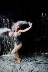 Girl dancer jumping and dancing in the white dust with flour on © AS Photo Family