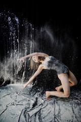 Girl dancer jumping and dancing in the white dust with flour on © AS Photo Family